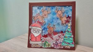 Shaker Card natalizia con Babbo Natale e renne che consegnano i regali